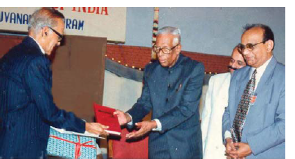 Dr. B. Ramamurthi handing over the first copy of Evolution of neurosciences in India to Dr Jacob Chandy at the Trivandrum Conference of Neurosciences Society of India. December 1998. (Left to right: Dr B. Ramamurthi, Dr Jacob Chandy, Dr M. Sambasivan and Dr K.R. Nair)